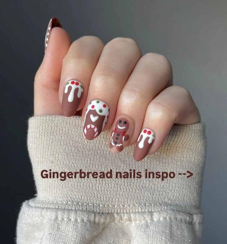 Brown rounded nails with gingerbread characters, white icing patterns, and colorful dots.